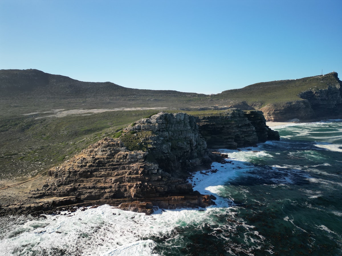 Rocky coastline with waves crashing against cliffs