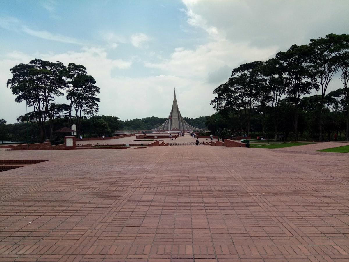 a view of a walkway with a pyramid in the background