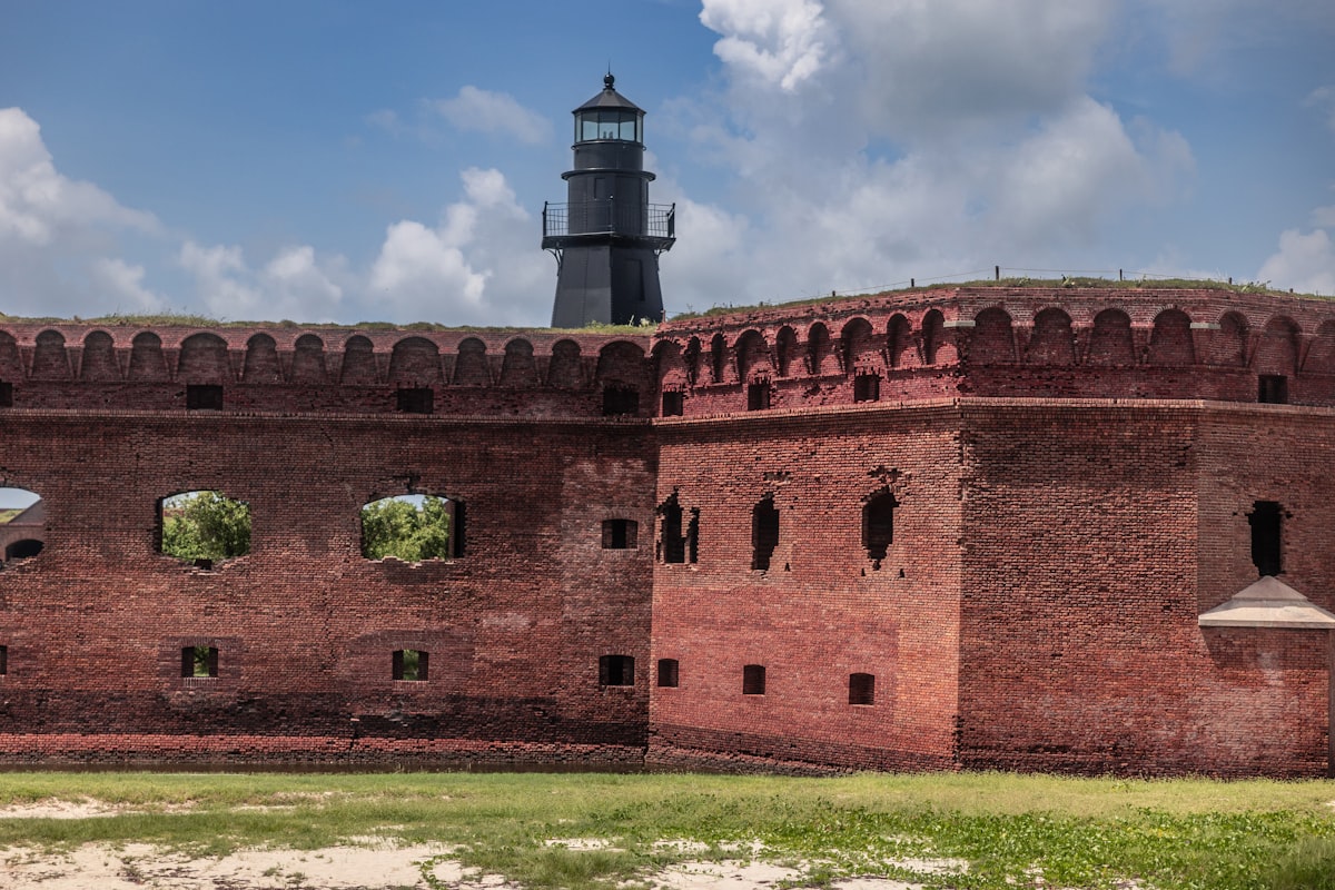 A large brick building with a light tower in the background