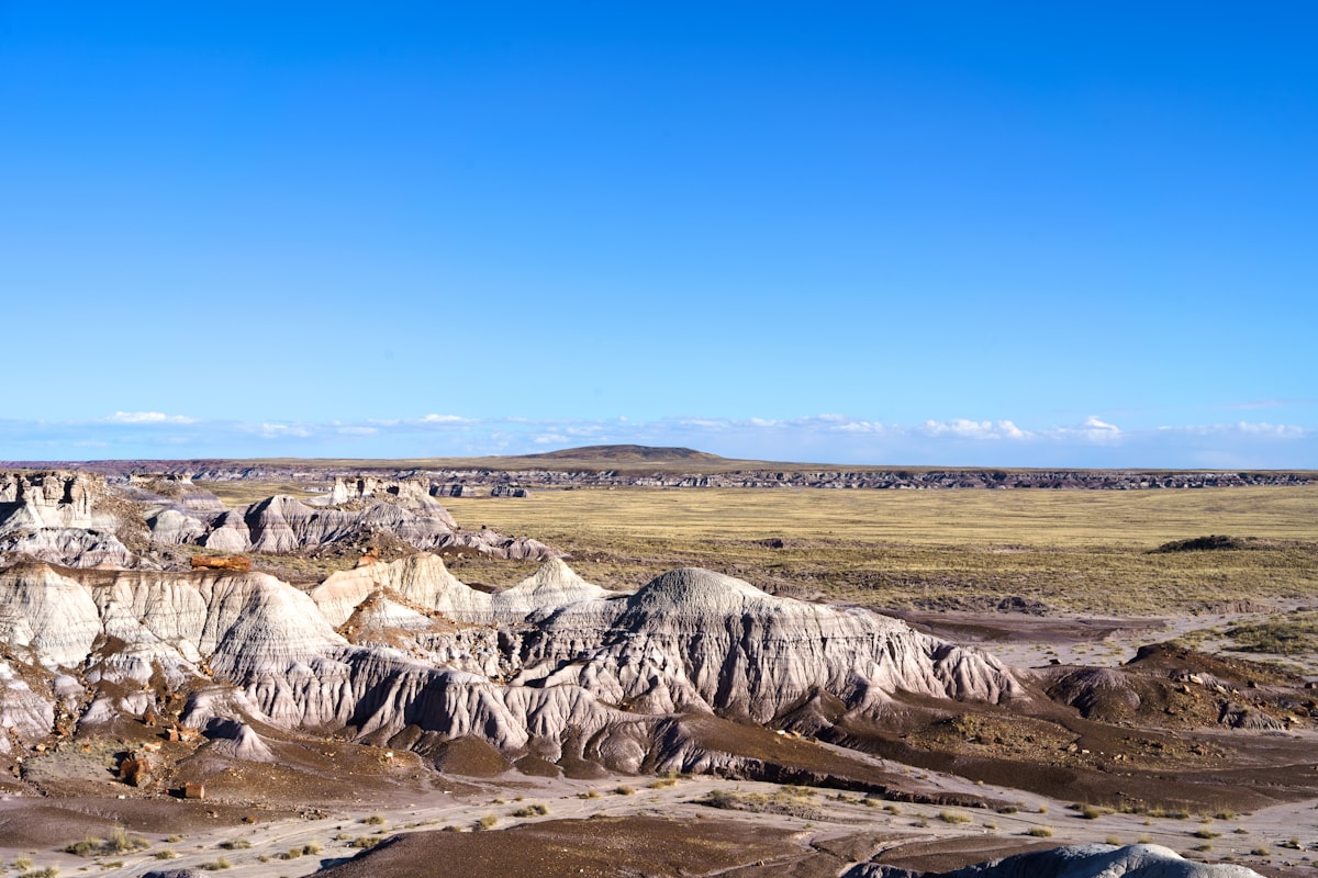 a view of a mountain range with a blue sky in the background