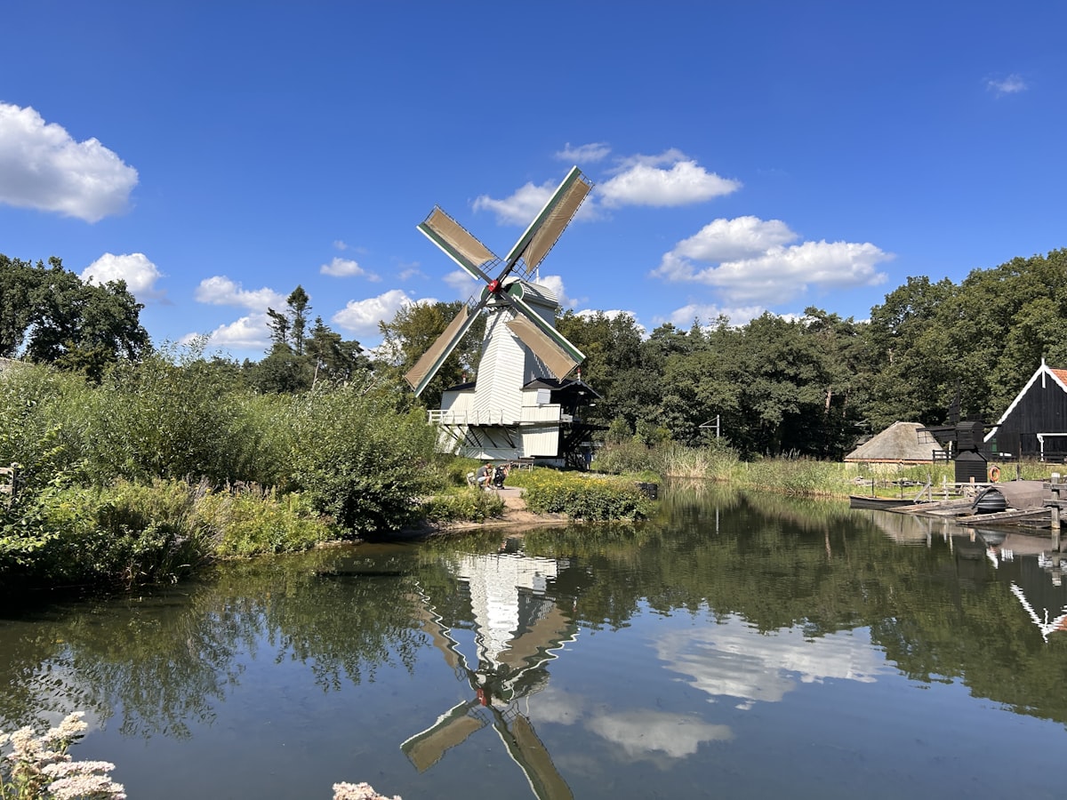 a windmill sitting next to a body of water