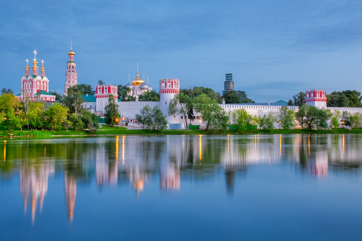 The novodevichy convent reflects in the water.
