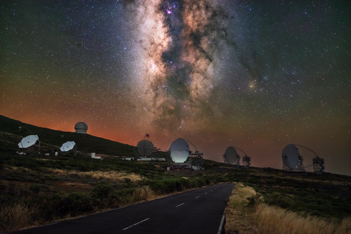 Observatory domes under the milky way at night.