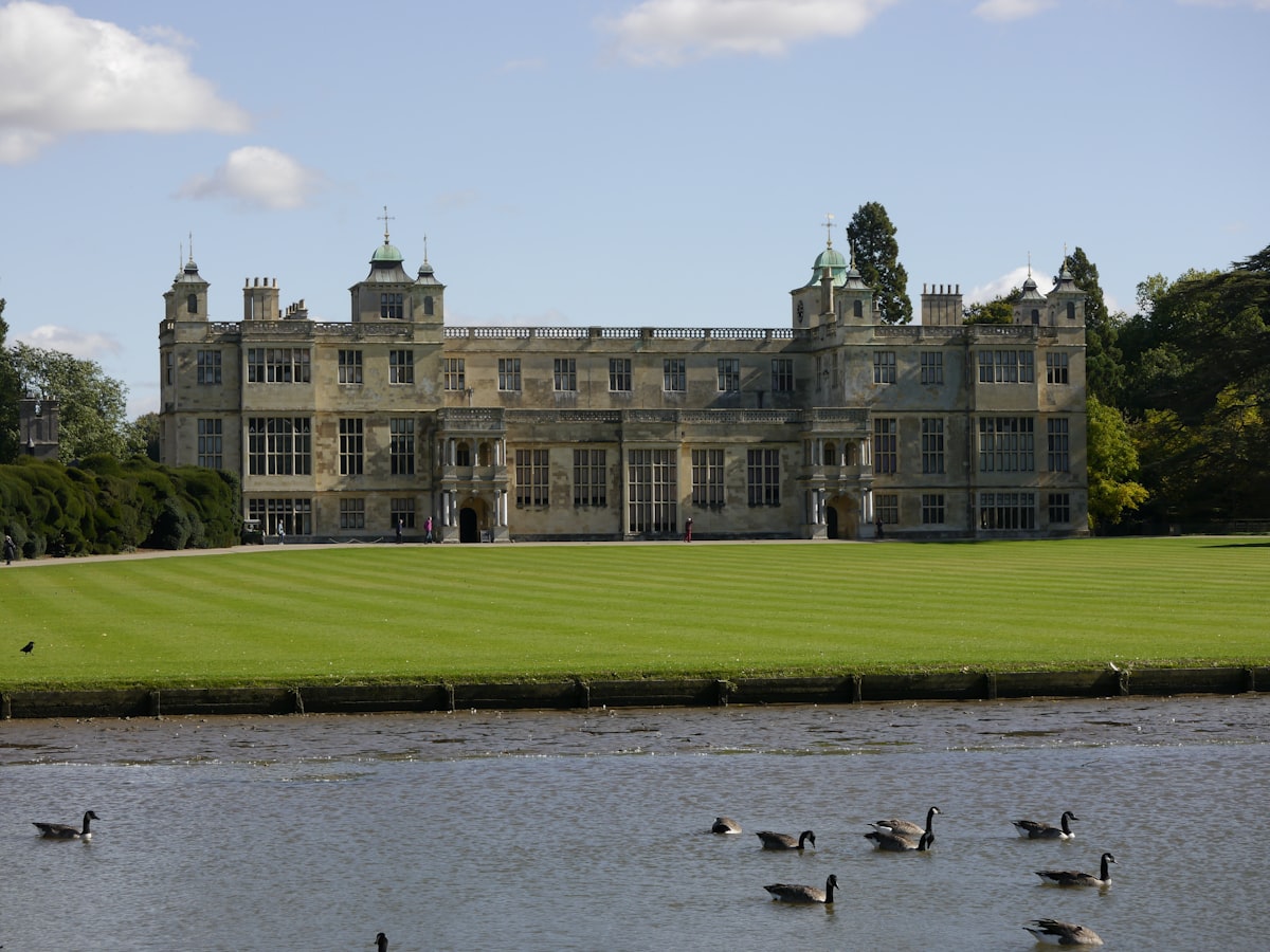 A large building sitting on top of a lush green field