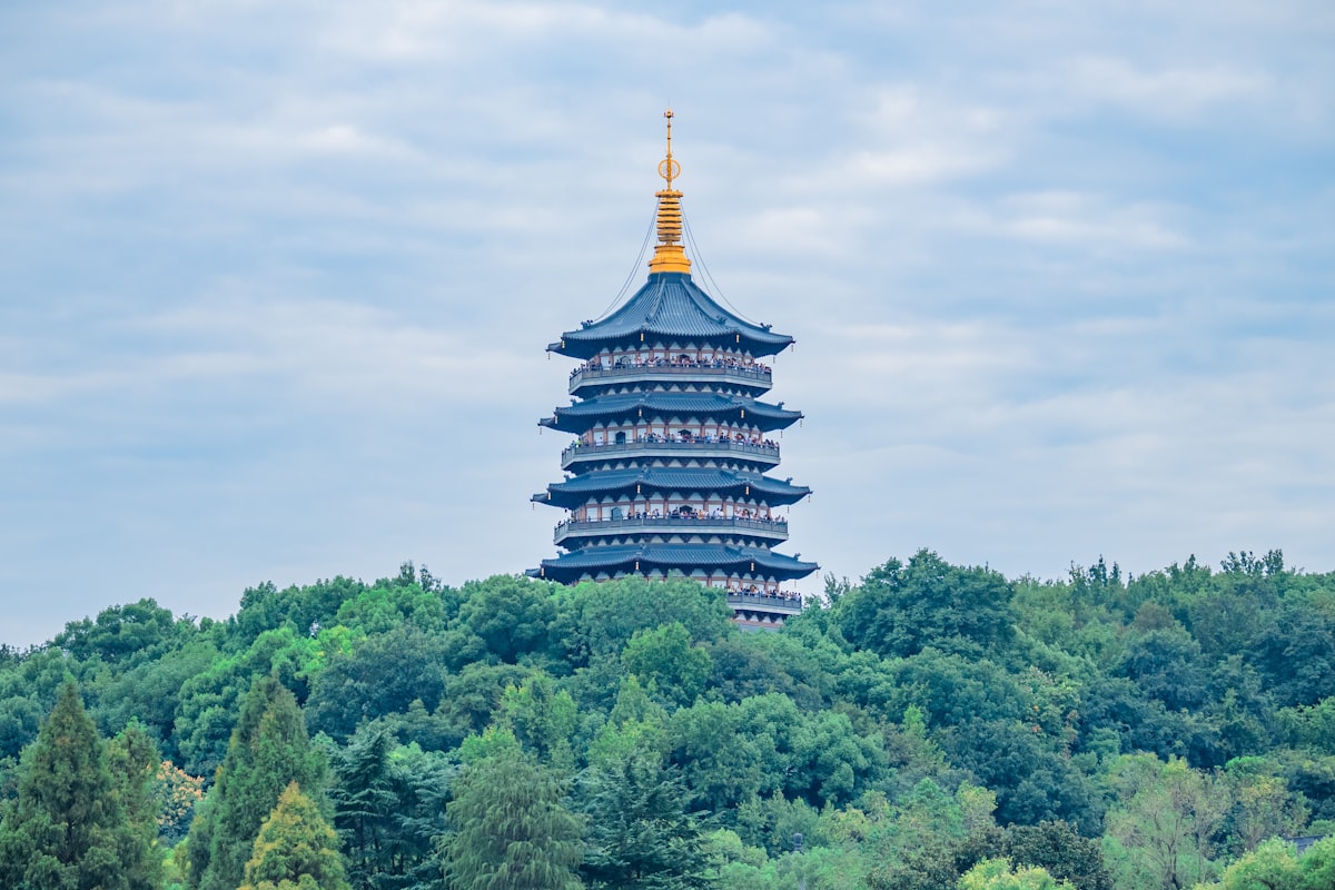 a tall tower sitting on top of a lush green hillside