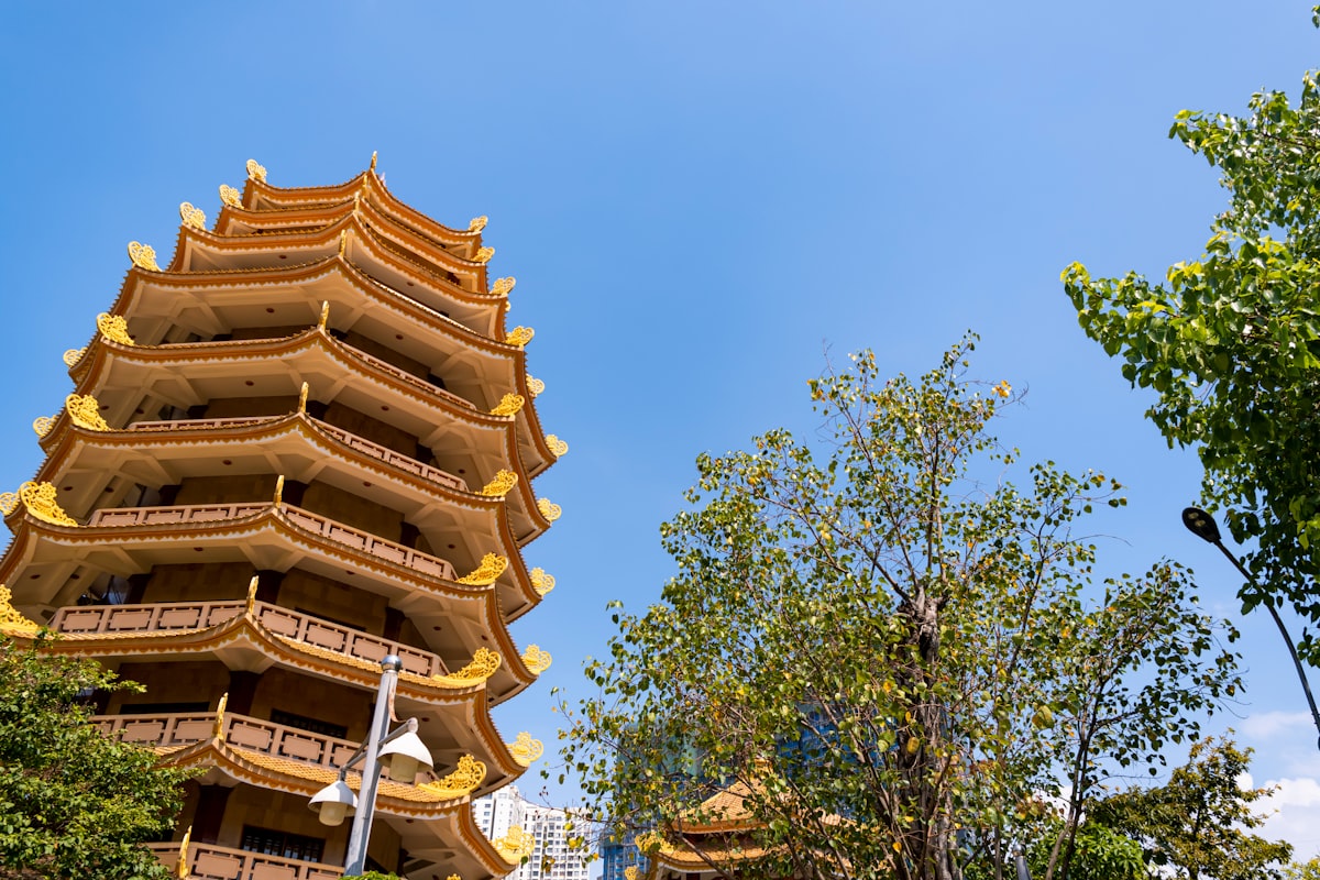 A tall, ornate pagoda against a clear blue sky.