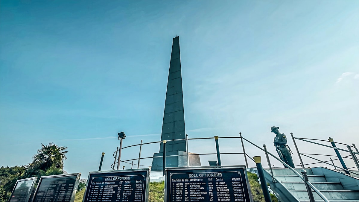 Tall obelisk monument with lists of names