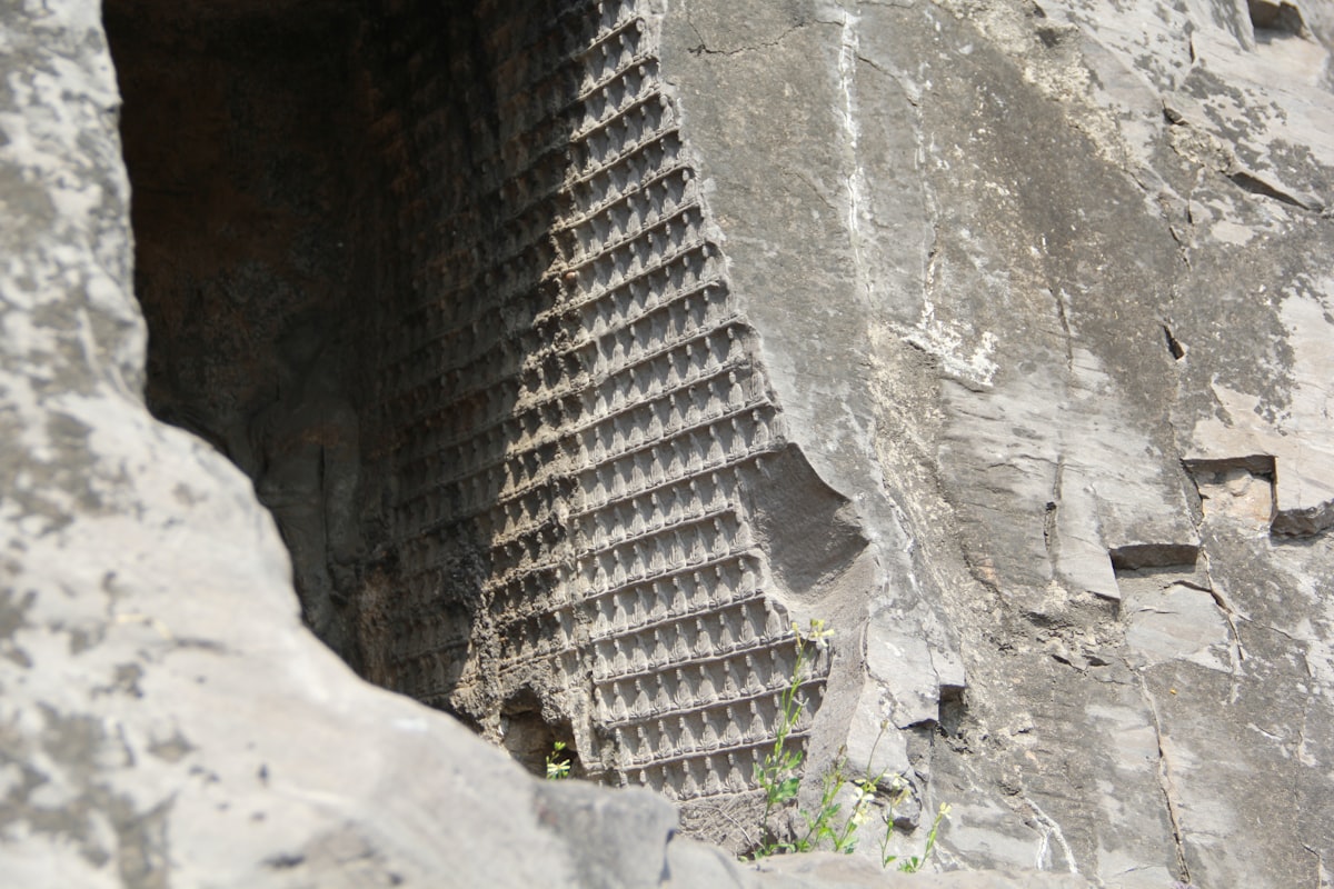 Carved rock face with geometric patterns and openings