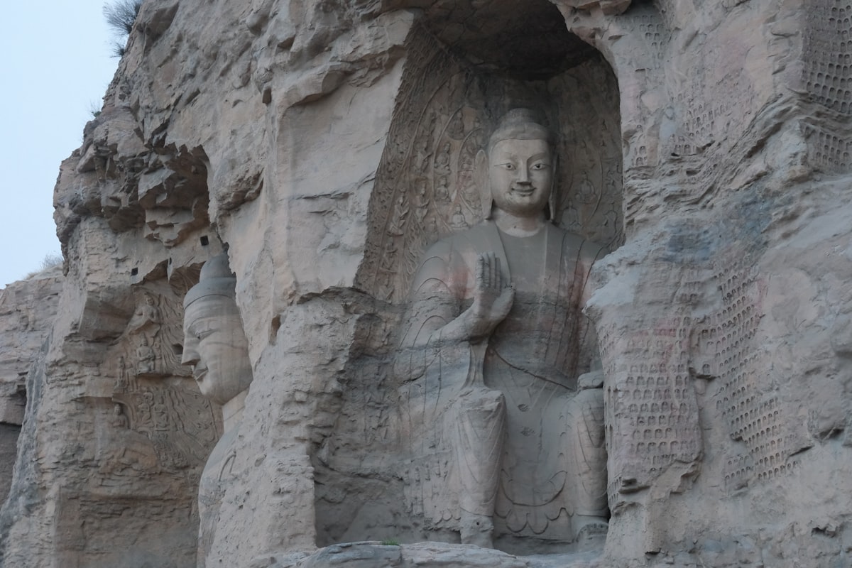 Ancient buddha carved into a rock face.