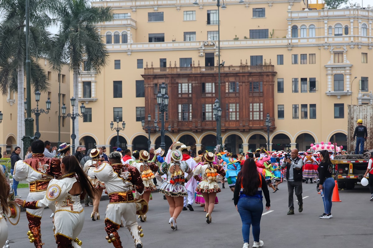 A large group of people walking around a street