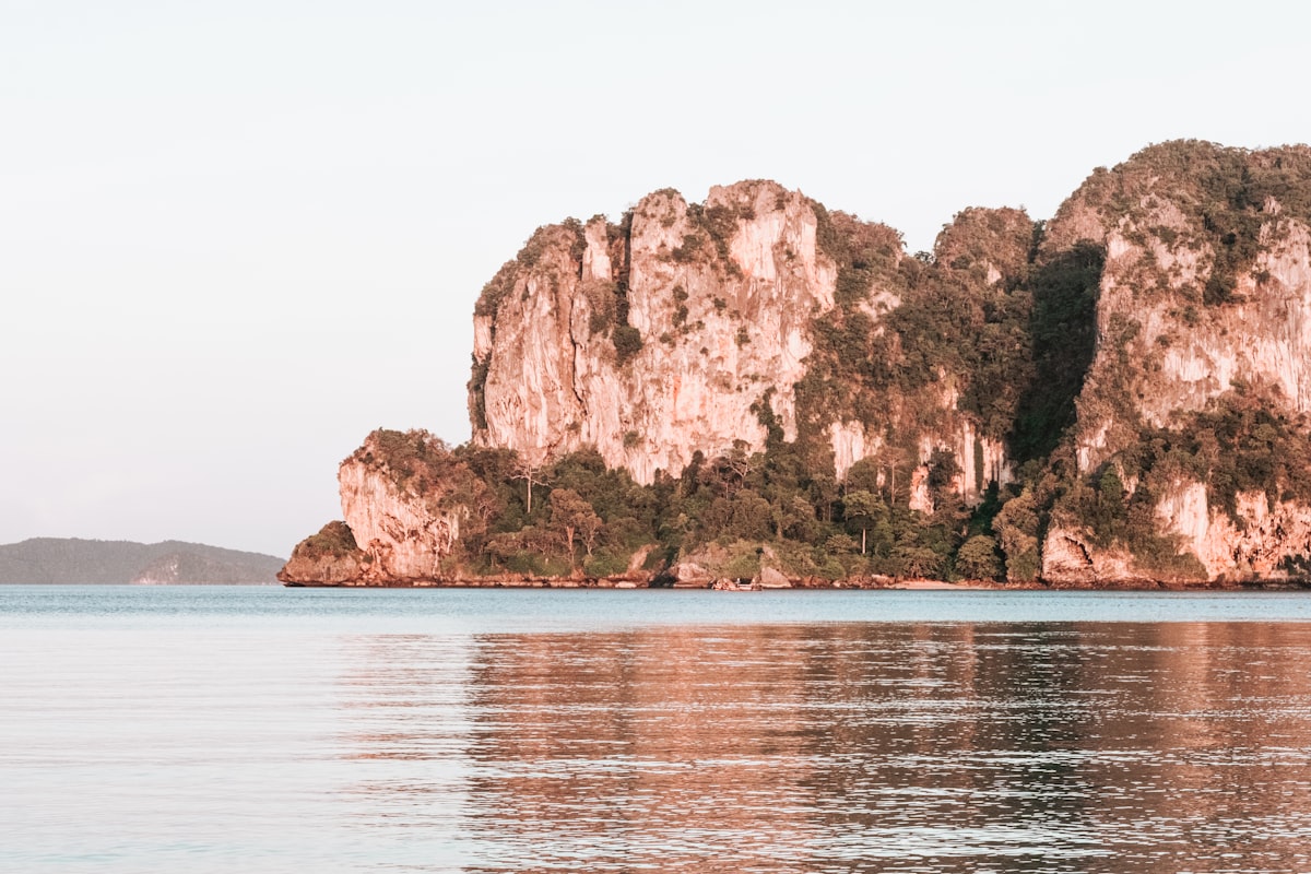 Rocky island reflected in calm water.