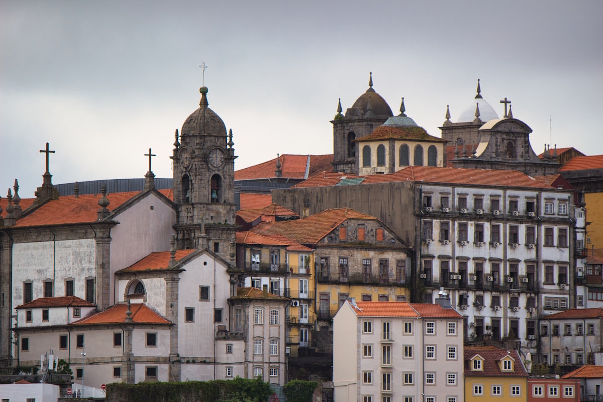 Cityscape of historical buildings with orange roofs.