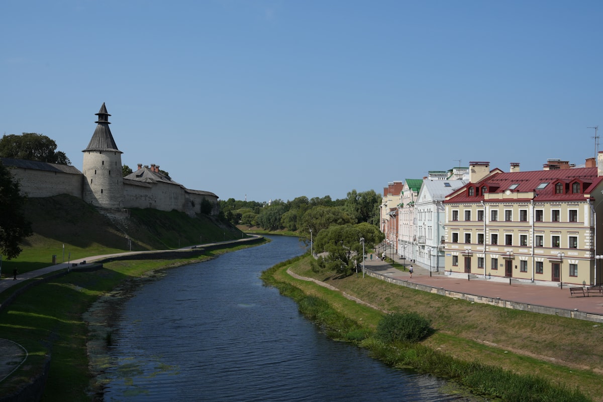 River flows past historic buildings and fortress