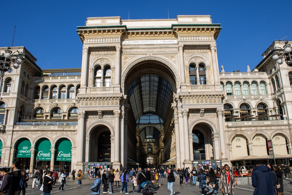 A large building with lots of people walking around it