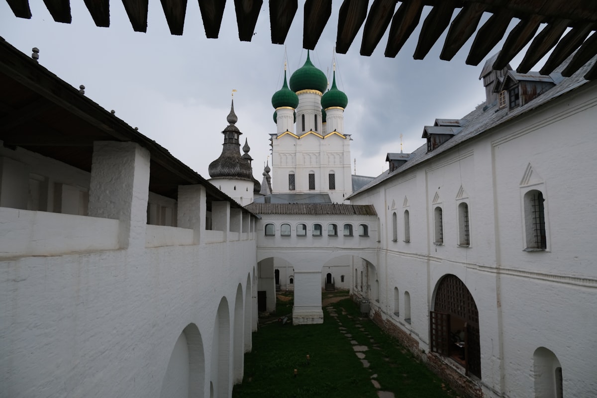 a large white building with a green dome