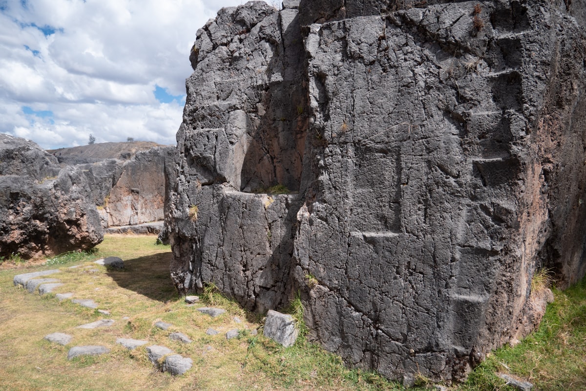 a large rock formation in the middle of a field