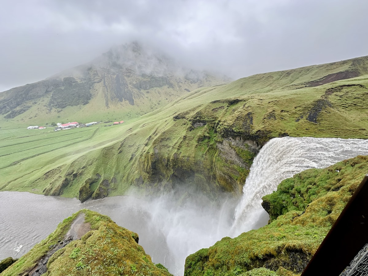 Majestic waterfall cascades down green mossy cliffs