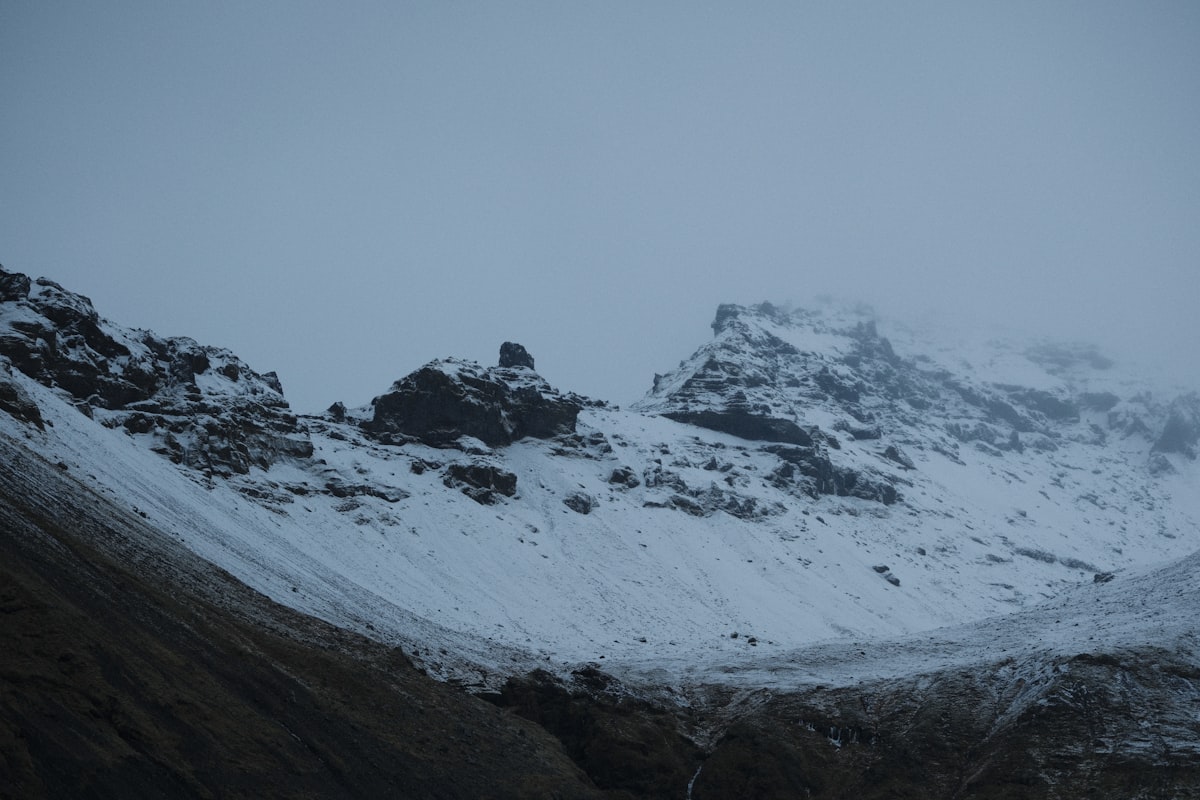 Snowy mountains under a foggy sky