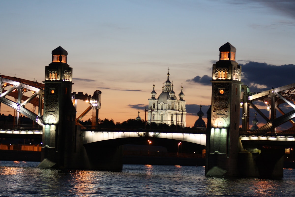 Bridge towers and church at dusk over water