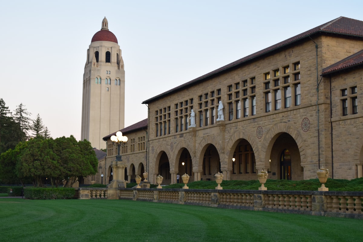 A beautiful campus building and tower are shown.