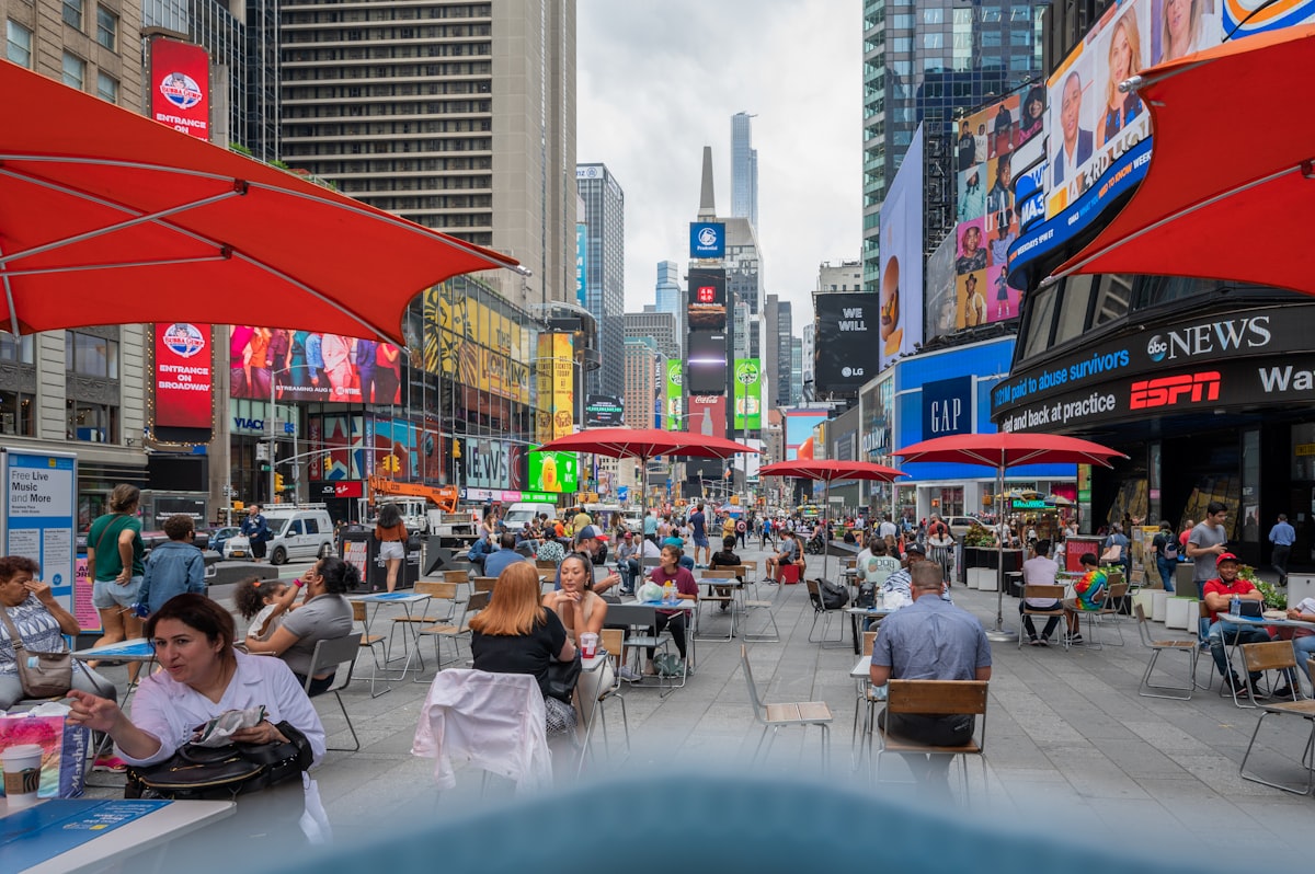 people sitting on chair near building during daytime