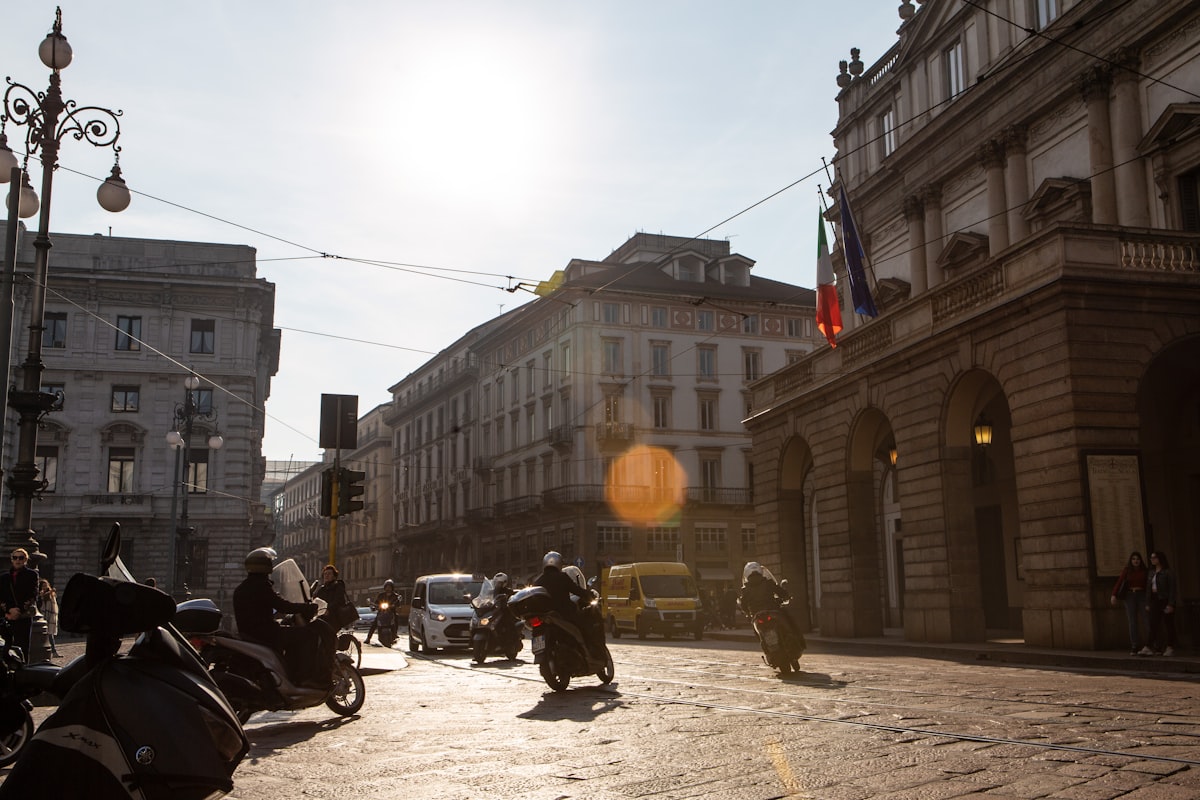 people riding motorcycle on road near buildings during daytime
