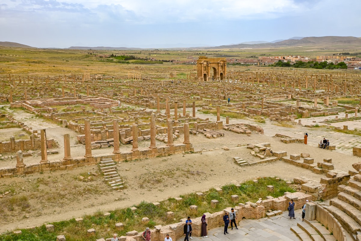 Ancient roman ruins stretch across a vast landscape.