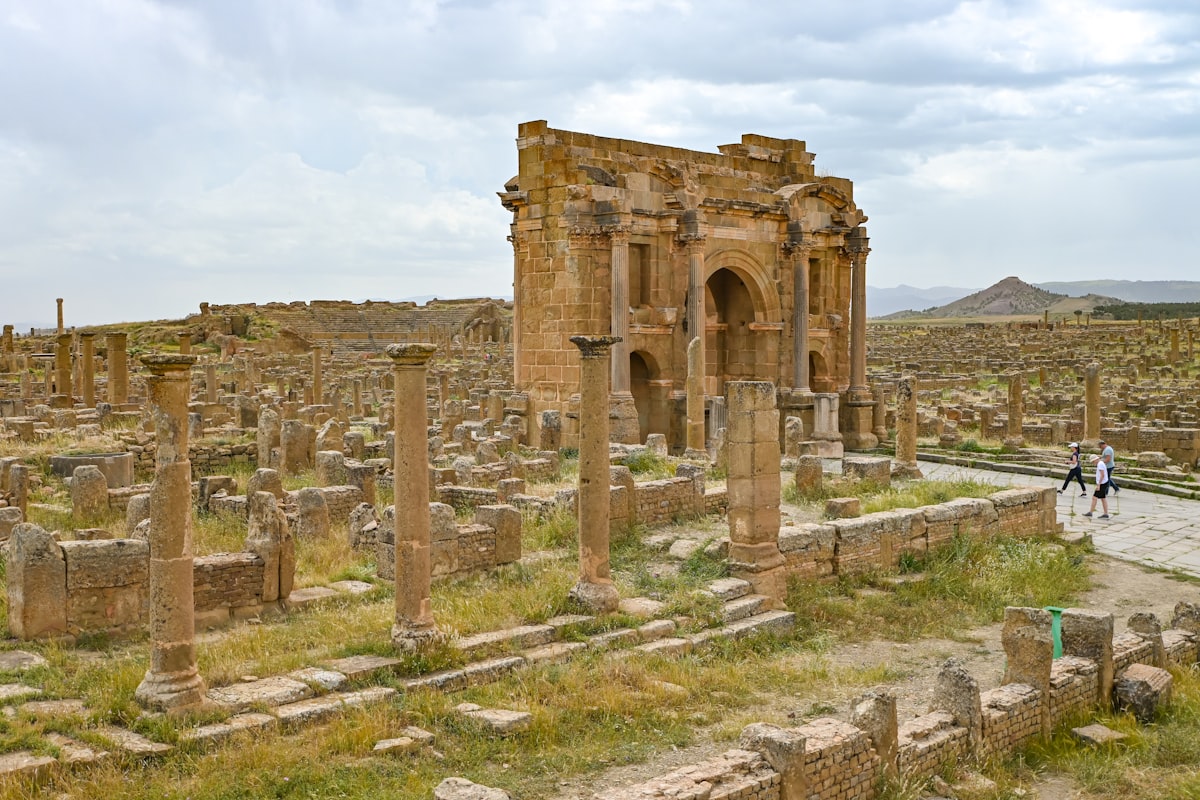 Ancient roman ruins stand in the desert landscape.