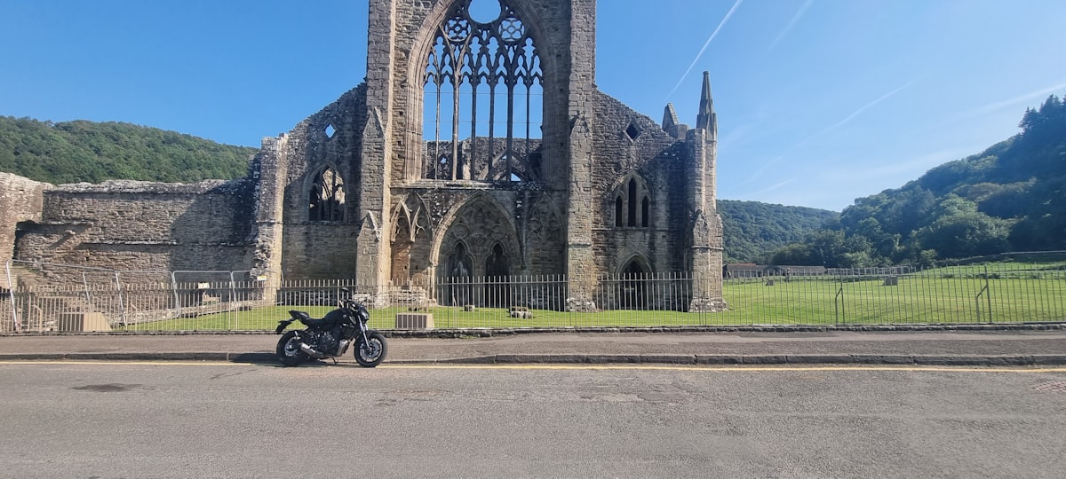 a motorcycle parked in front of a stone building