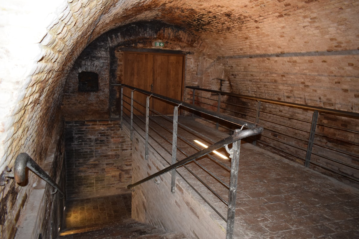 an old brick tunnel with stairs leading up to a door