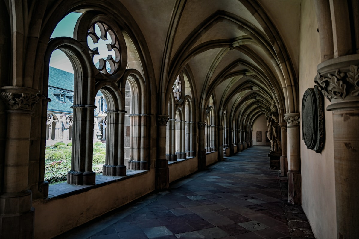 An arched hallway with ornate windows.