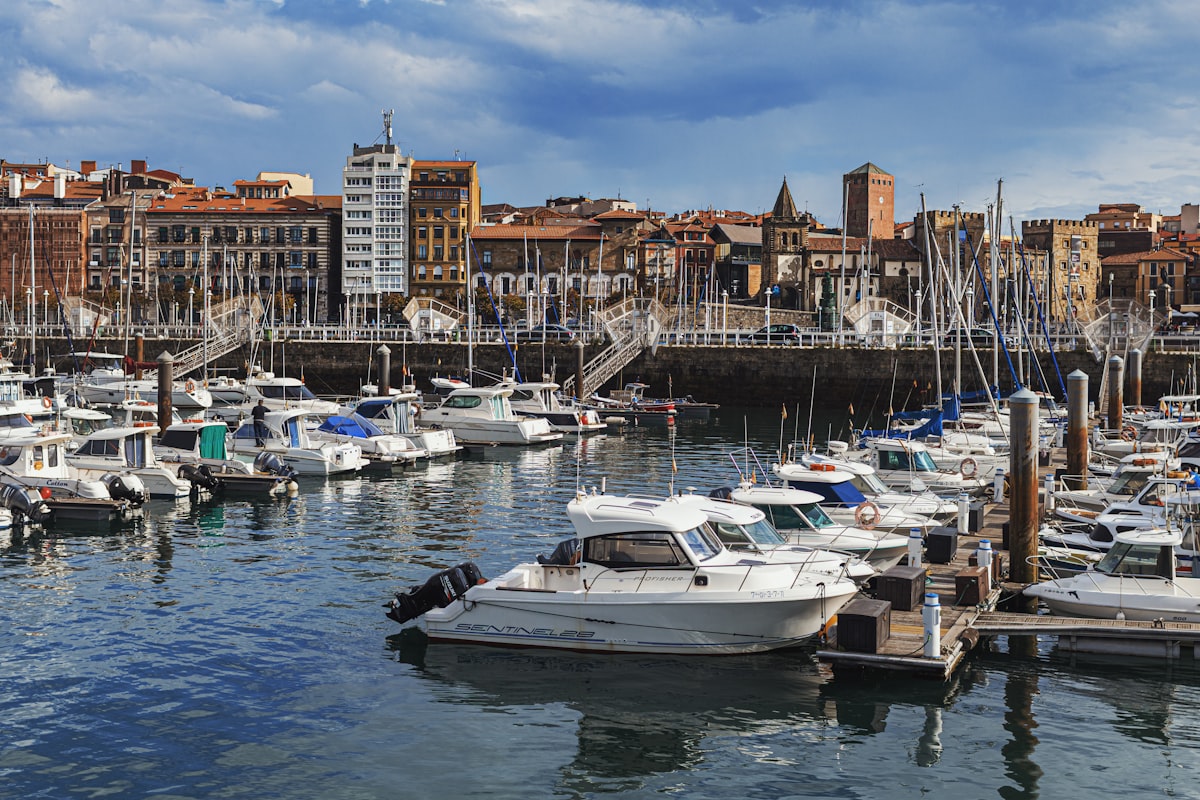 Boats docked in a harbor with buildings in background
