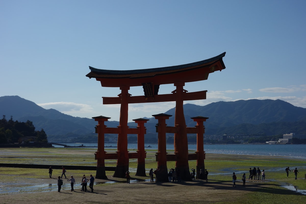 a group of people standing in front of a tall structure