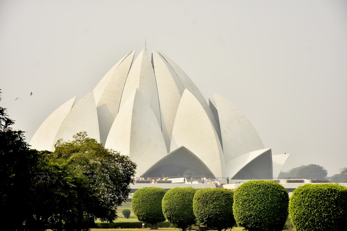 a large white building surrounded by trees and bushes