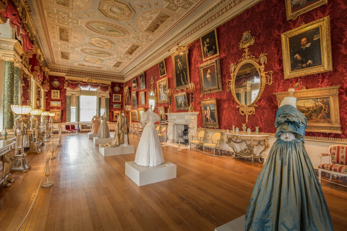 Elegant ballroom with historical dresses on display
