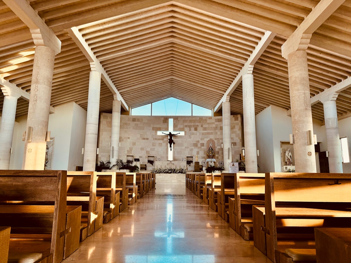 The inside of a church with wooden pews