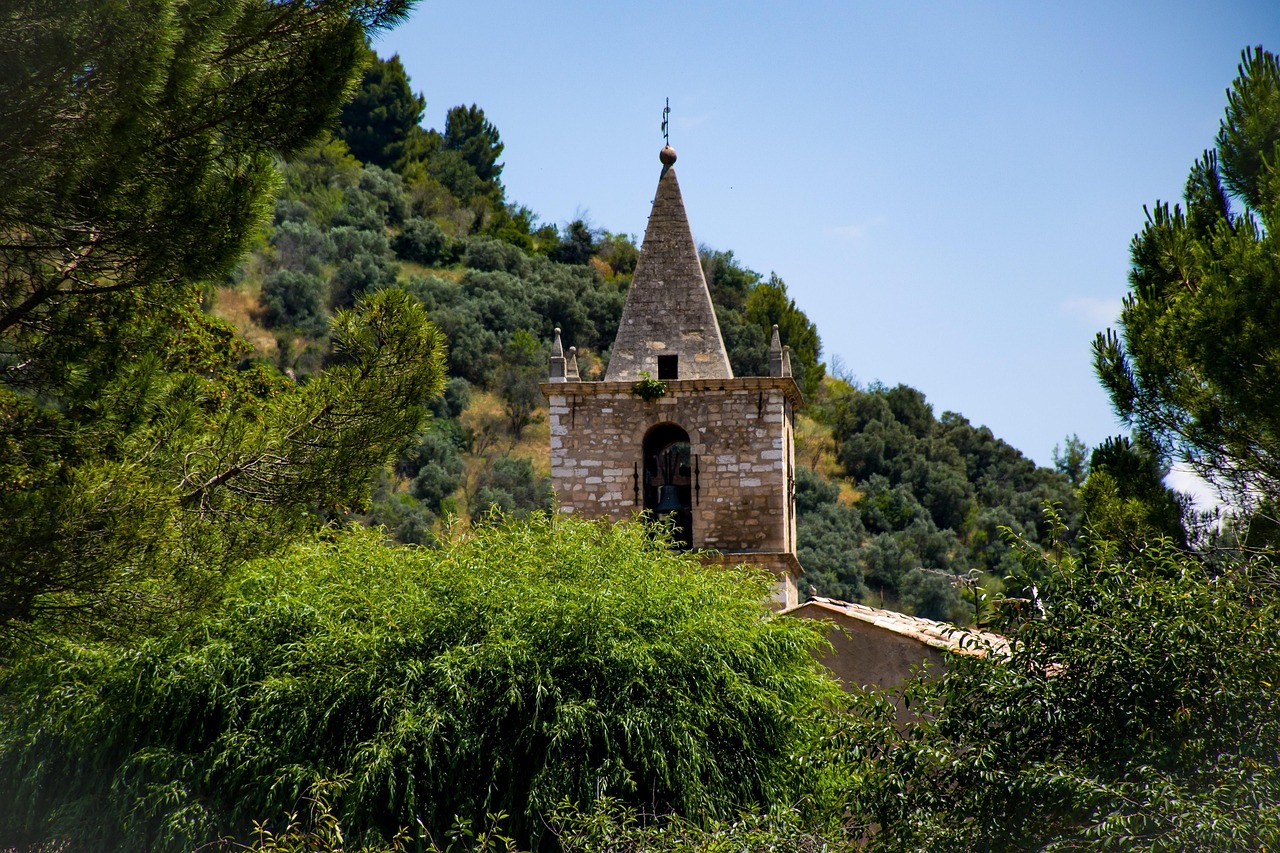 riez, france, provence, south of france, southern france, europe, eglise, church, steeple, ancient, medieval, provencal, old world, trees, greenery, foliage, hillside village, bell tower, architecture, tourism, nature, explore
