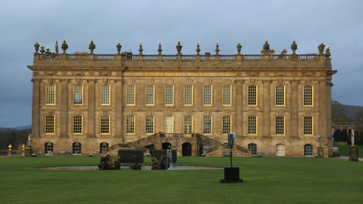 a large building with a large lawn in front of it