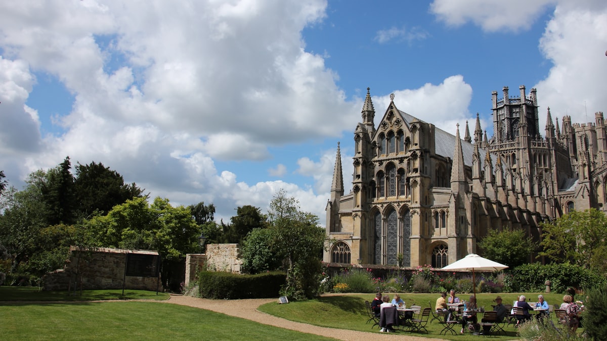 A group of people sitting outside of a large building