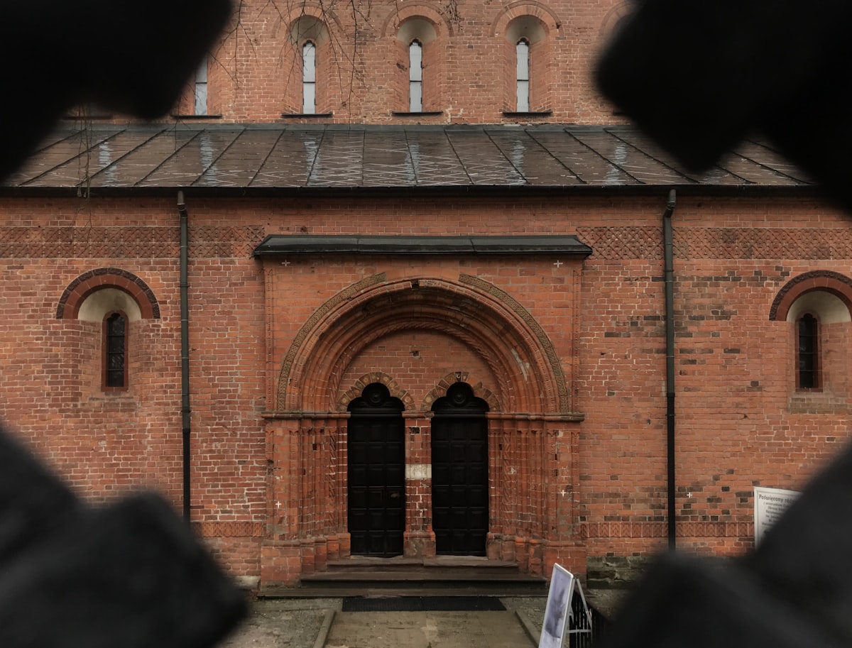 a large brick building with a clock tower in the background