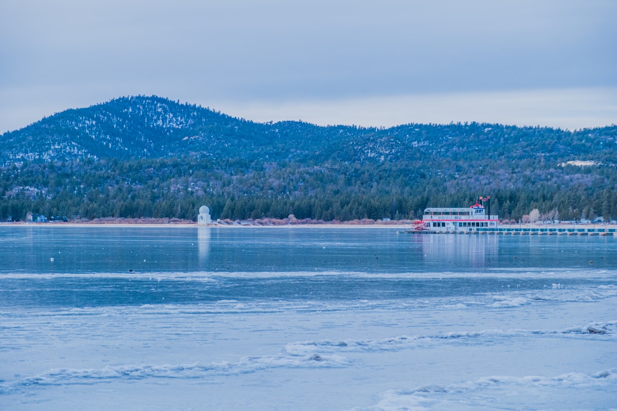 a large body of water with a boat in the distance