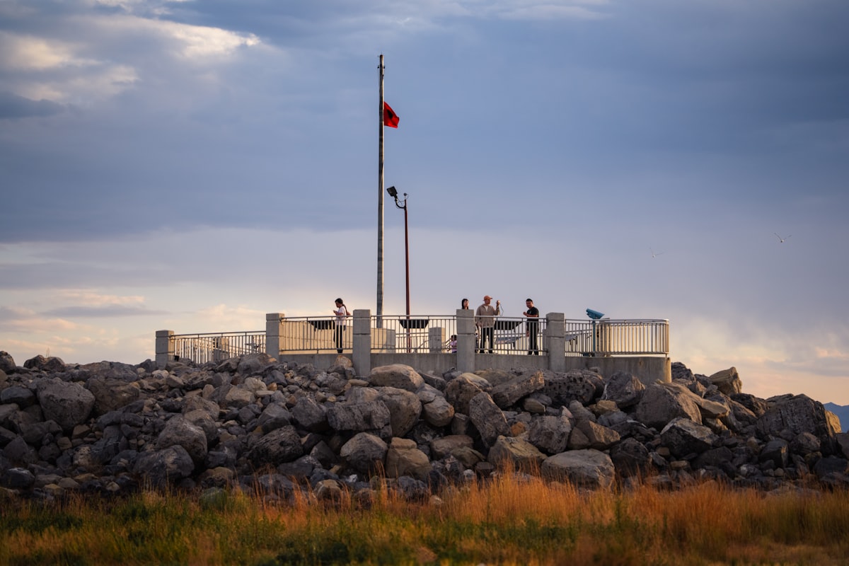Flagpole on a rocky hill at dusk