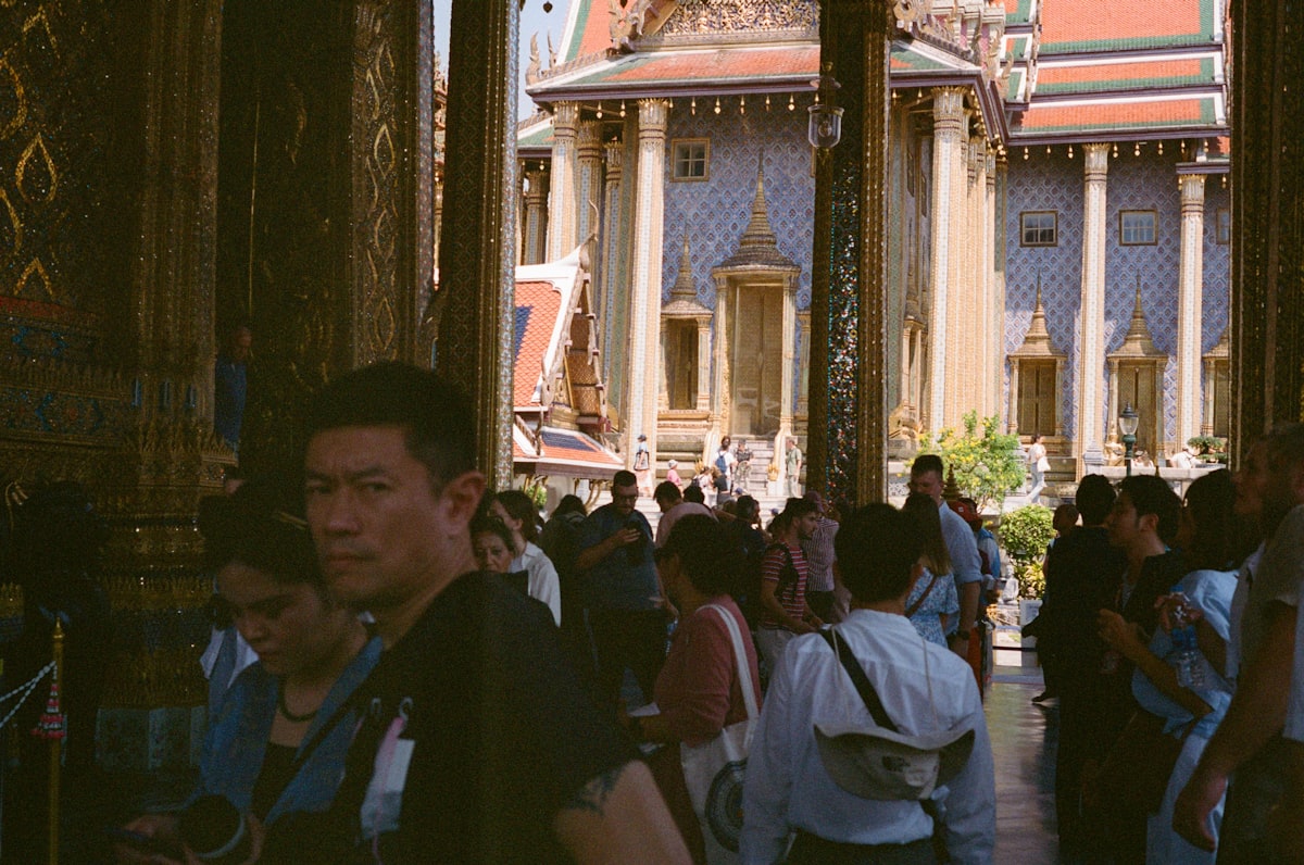 Tourists walking through a temple courtyard