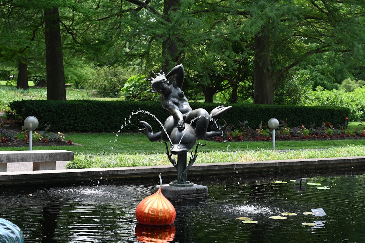 a fountain with a statue in the middle of it