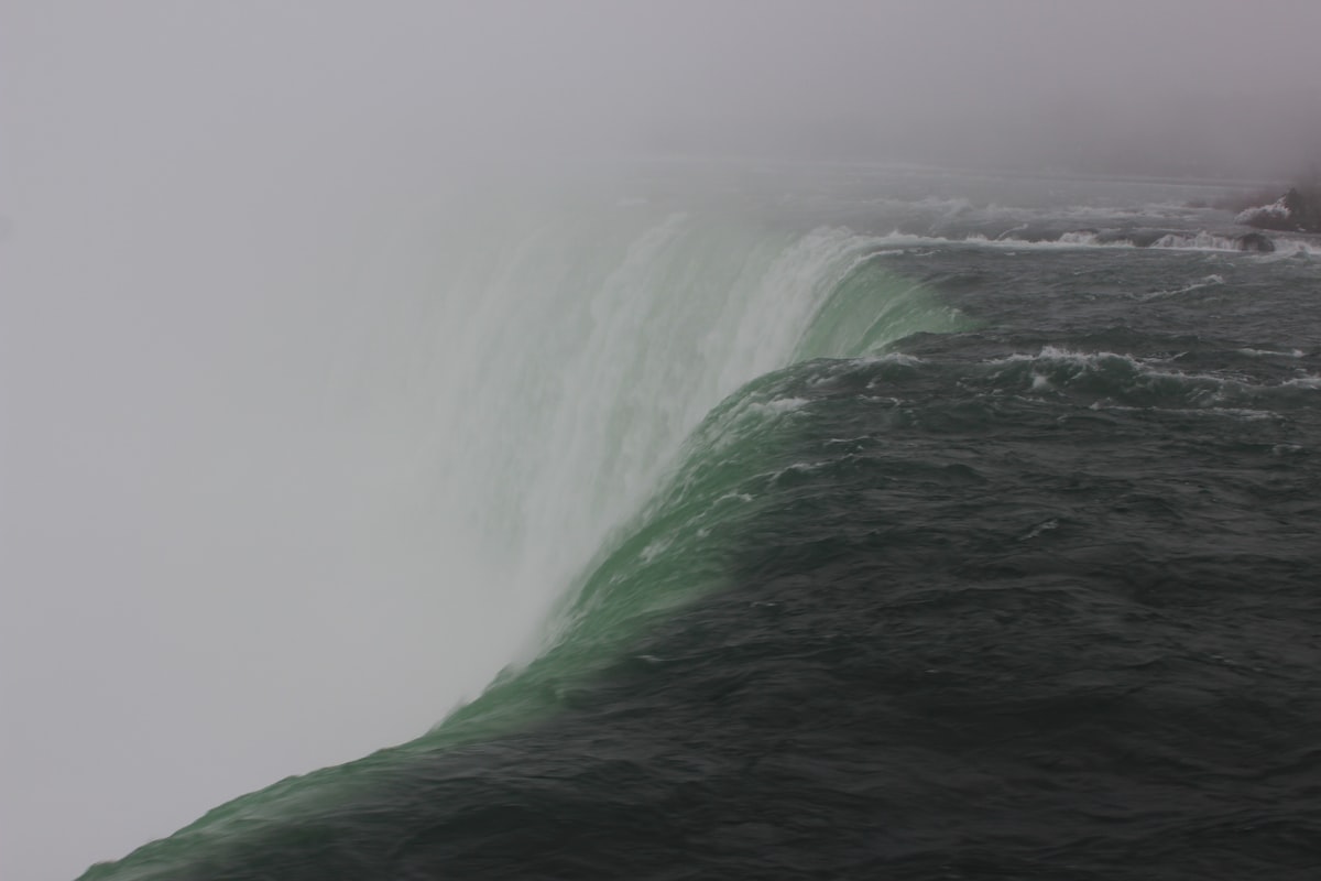 water falls under gray sky