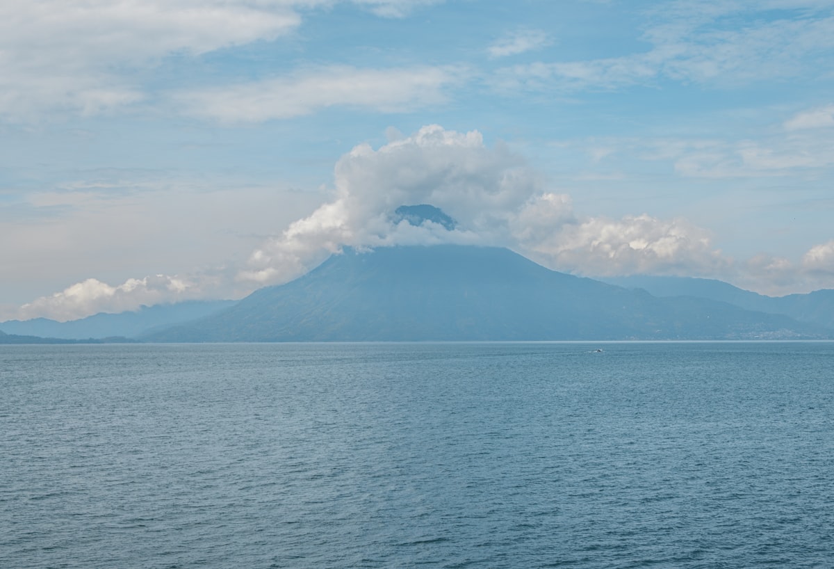 A large body of water with a mountain in the background