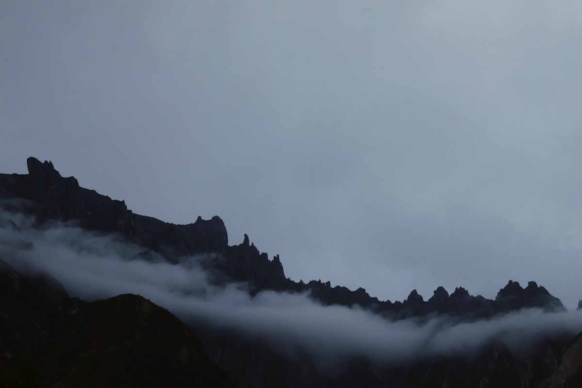 Jagged mountain peaks shrouded in mist