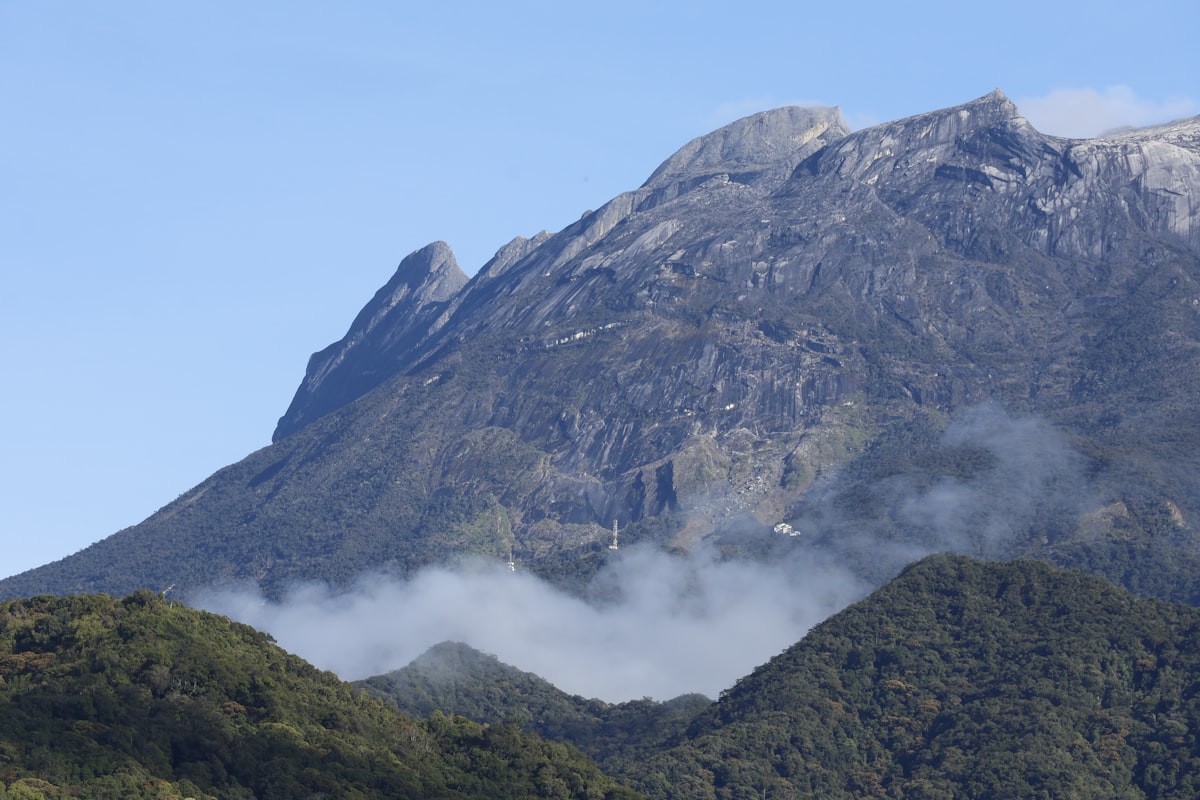 Majestic mountain peak shrouded in mist and clouds.
