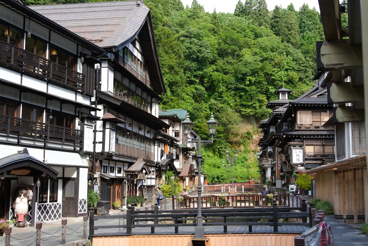 Traditional japanese buildings nestled in lush green mountains