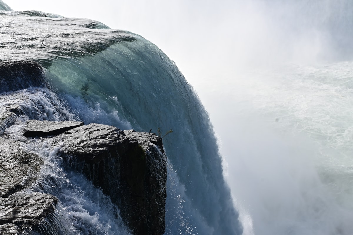 a man standing on the edge of a waterfall